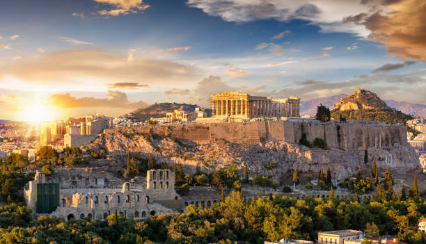 Athens The Acropolis of Athens, Greece, with the Parthenon Temple on top of the hill during a summer sunset