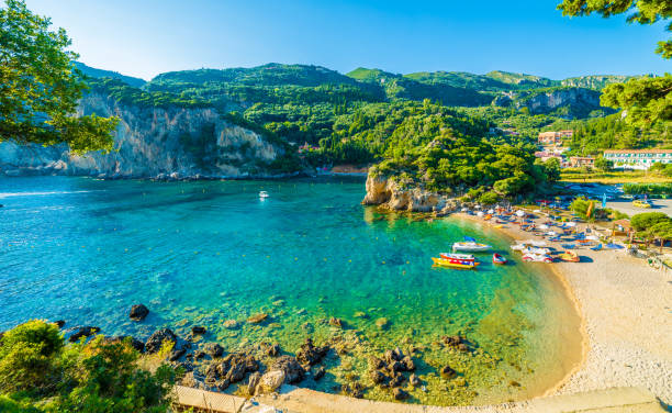 Beautiful beach and boat in Paleokastritsa, Corfu island, Greece Beautiful beach and boat in Paleokastritsa, Corfu island, Greece