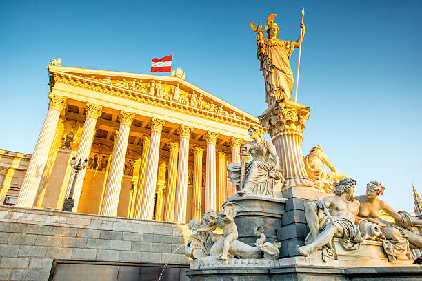 Austrian parliament building with Athena statue on the front in Vienna on the sunrise