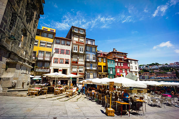 Ribeira Square Porto, Potugal - June 11, 2015: Tourists visit restaurants at famous place Ribeira Square at day time